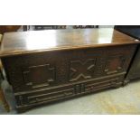 Large heavy oak coffer having moulded hinged top above carved indented foliate decoration, with