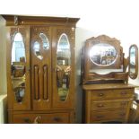 Art Nouveau design oak carved bedroom suite comprising two door mirrored and bevelled wardrobe and a