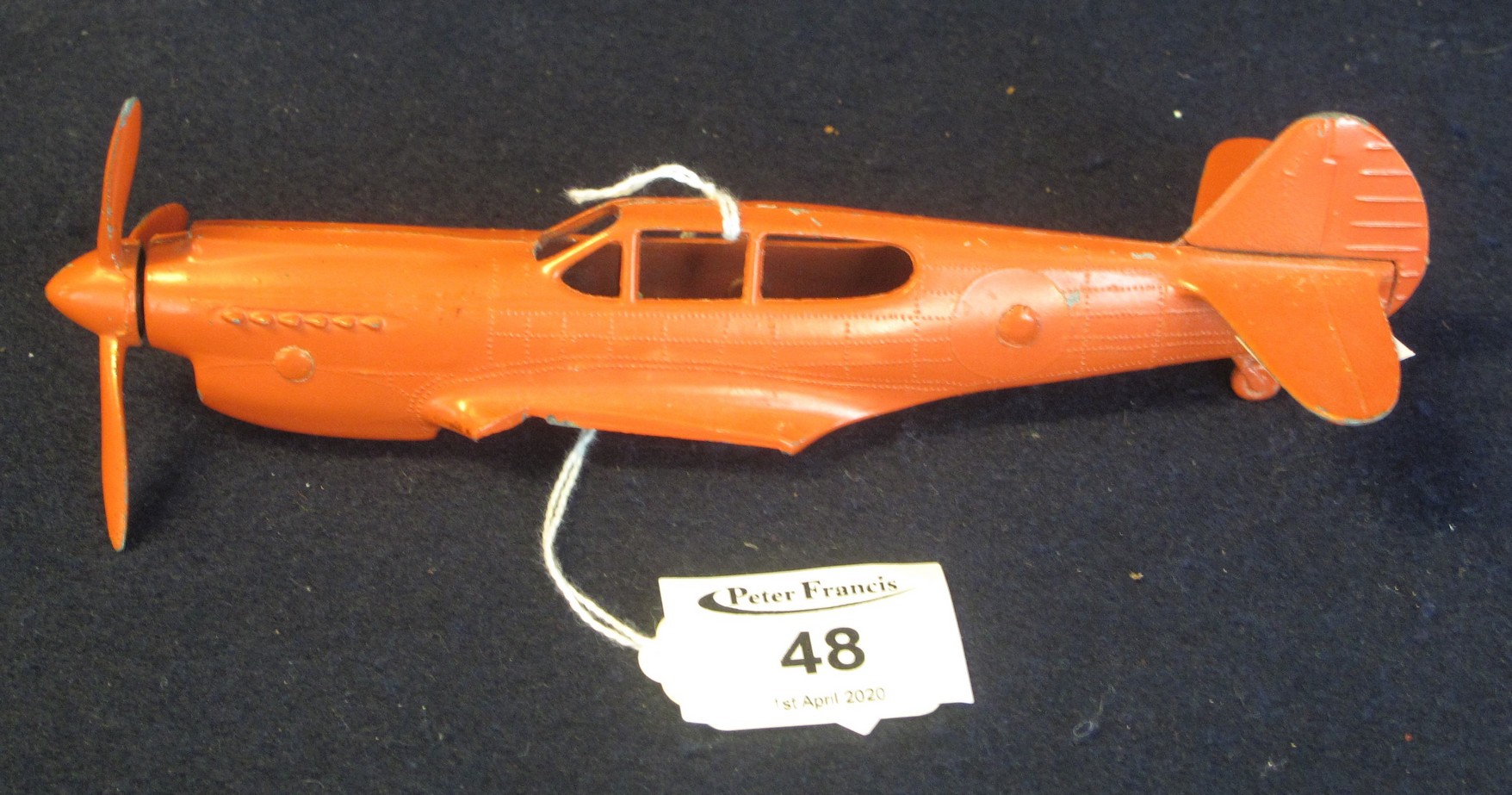 A diecast model metal fighter aircraft fuselage (possibly a Curtiss Kittyhawk), lacking wings. (B.P.