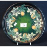 Modern Moorcroft art pottery tube lined cabinet plate or charger, overall on a green ground