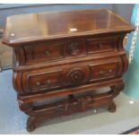 Modern hardwood sideboard having moulded top above two fitted drawers standing on a turned and