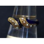 A Victorian mourning ring in blue enamel with seed pearls, with hair locket section to reverse.