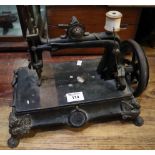 Vintage hand sewing machine with open frame and base supported on winged lion feet. (B.P. 24%