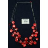 A red bead costume necklace. (B.P. 24% incl. VAT)