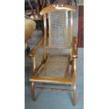 Walnut folding armchair with cane decoration, 20th Century. (B.P. 24% incl. VAT)