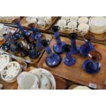 Two trays of Torquay ware pottery Lemon and Crute candlesticks and chamber sticks, mainly on blue