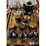 15 piece Prinknash coffee set on a black ground with enamelled bluebells and giltwork. (15) (B.P.