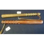 Two turned wooden truncheons with leather wrist thongs. (2) (B.P. 24% incl. VAT)