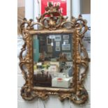 Modern gilt framed mirror with pierced floral and foliate decoration. (B.P. 24% incl. VAT)