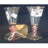 Pair of firing glasses with red and white opaque air twist stems. (2) (B.P. 24% incl. VAT)