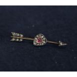 A diamond and ruby heart and arrow brooch, 2.7g approx. (B.P. 24% incl. VAT)