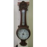 Early 20th Century carved oak aneroid barometer. (B.P. 24% incl. VAT) The enamel face is badly