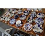 Three trays of 19th Century 'Gaudy Welsh' cabinet cups and saucers of varying designs and