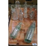 Collection of cut and coloured glass items to include; viniagrettes and stoppers, cod bottles