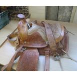 European leather foliate decorated horse saddle, probably Spanish. (B.P. 24% incl. VAT)