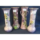 Pair of Torquay ware hand painted cylinder vases with flower head decoration and baluster bases,