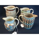 Four 19th Century mocha ware jugs of checkered, marbled and other decoration. (4) (B.P. 24% incl.