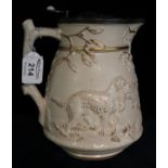 Large Victorian jug with shell decorated pewter lid, the body embossed with gilt and animal