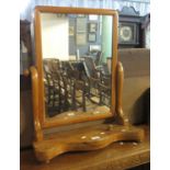 Victorian mahogany swivel mirror with shaped front on bun feet. (B.P. 24% incl. VAT)