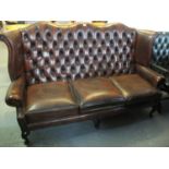 Modern burgandy chesterfield style three seater wing sofa on cabriole legs. (B.P. 24% incl. VAT)