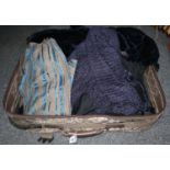 Suitcase containing; early 20th/late 19th Century clothes including; three black aprons, ladies