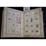 Leather bound album of printed crests and monograms, applied to pages, dated 1864. (B.P. 24% incl.