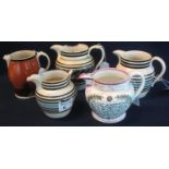 Four 19th Century mocha ware jugs of baluster form, varying decoration. Together with a 19th Century