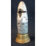 Trench art money box in the form of an upright white and yellow metal artillery shell, with cross