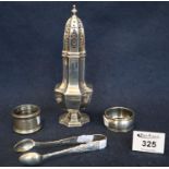 Assorted silver items to include; two napkin rings, sugar tongs and sugar caster. 5.8 troy ozs