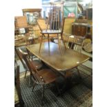 Elm Ercol refectory kitchen table, together with a set of six Ercol spindle chairs including two