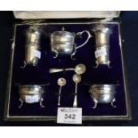 Silver five piece condiment set to include; two open salts with blue glass liners, two pepperettes