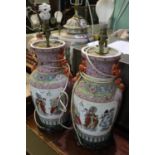 Pair of Chinese porcelain baluster vases decorated with reserved panels of figure groups within