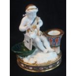 19th Century porcelain taper stick, gilt and enamelled and modelled as a maiden with white dove at a