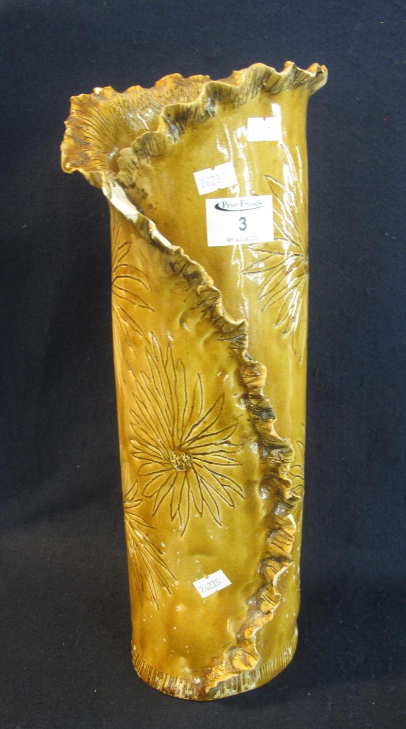 Large brown pottery cylinder vase with frilled edges and foliate decoration, marked to the base