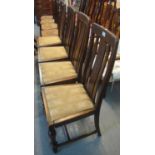 Set of four early 20th Century oak slat back dining chairs with drop in seats on turned supports. (