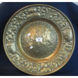 19th Century repousse brass wall hanging dish decorated with fighting mounted knights within