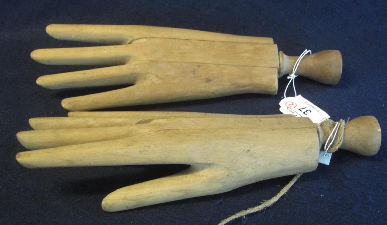 Pair of moulded wooden hands with turned wooden handles, probably for shop display purposes. 28cm