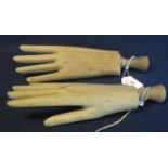 Pair of moulded wooden hands with turned wooden handles, probably for shop display purposes. 28cm