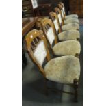 Set of six modern oak spindle dining chairs with upholstered backs and seats on turned supports