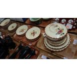 Three trays of French pottery dinnerware items on a cream ground with floral sprays to include;
