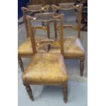 Set of three Edwardian walnut foliate carved dining chairs with tan leather upholstery on ring