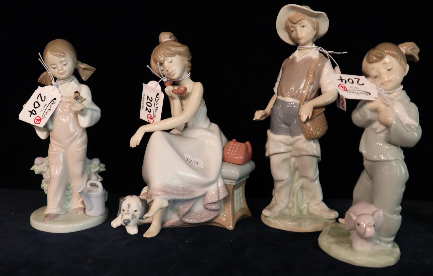 Three Lladro Spanish porcelain figurines, two girls with puppy and bird, together with a Nao Spanish