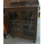 Early 20th Century oak two door display cabinet with adjustable shelves. (B.P. 21% + VAT)