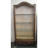 French walnut and mixed woods dome top display cabinet with glass shelves standing on carved foliate