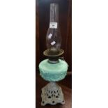 Early 20th Century double oil burner lamp with clear glass chimney, turquoise reservoir with rams