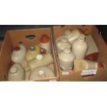 Two boxes of assorted stoneware hot water bottles with varying designs, one marked 'Haskins