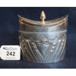 Small silver boat shaped repousse decorated tea caddy with hinged cover (hinge broken). Sheffield