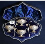 Cased set of silver rococo style two handled pedestal salts, matching foliate spoons. hallmarks, 6.5