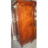 Victorian mahogany single door blind panelled wardrobe on turned supports. (B.P. 21% + VAT)
