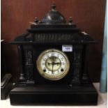 Black slate and marble architectural two train mantel clock with exposed escapement. 42cm high